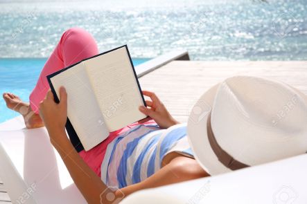 24761864-Woman-reading-book-relaxed-in-deck-chair-Stock-Photo